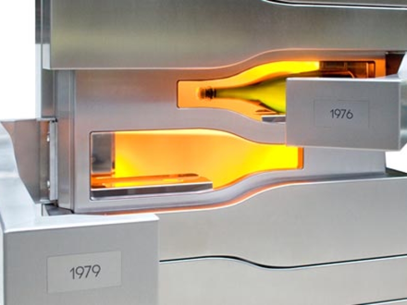 Gegenteilig öffnende Türflügel in Form einer Champagnerflasche (Champagnerkühlschrank mit oranger Beleuchtung der Flaschen-Lagerfläche)